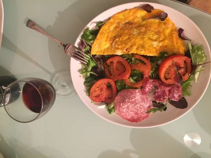 omelet, salad, cooked tomatoes, salami